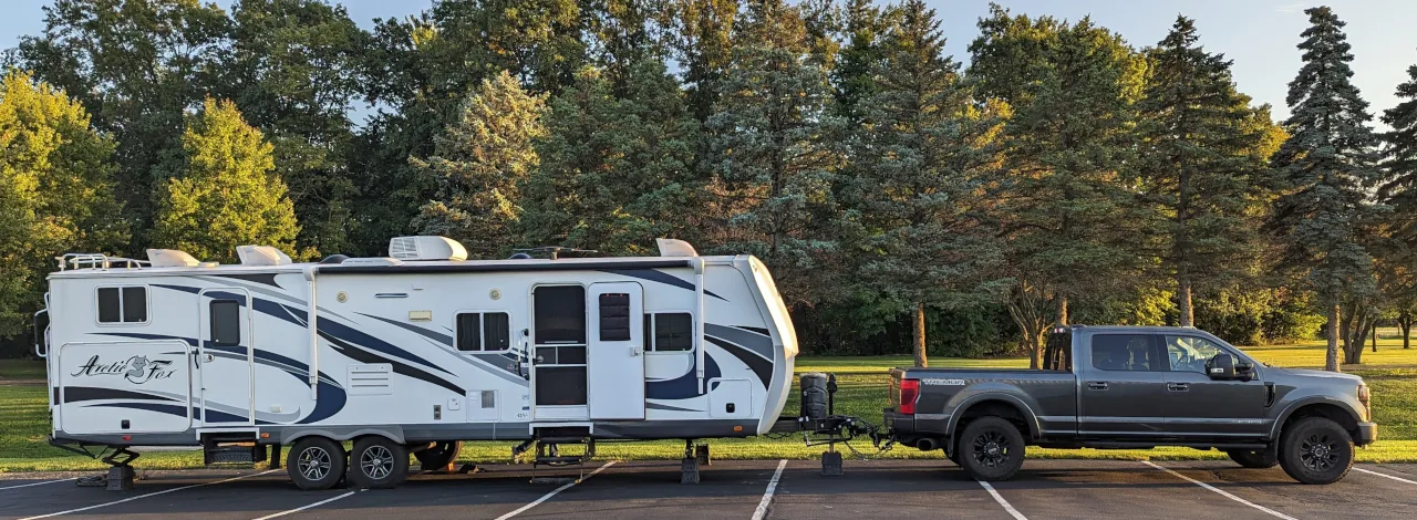 The Nomad Black Book travel trailer parked at Snooks Dream Cars, a Harvest Hosts stop in Ohio